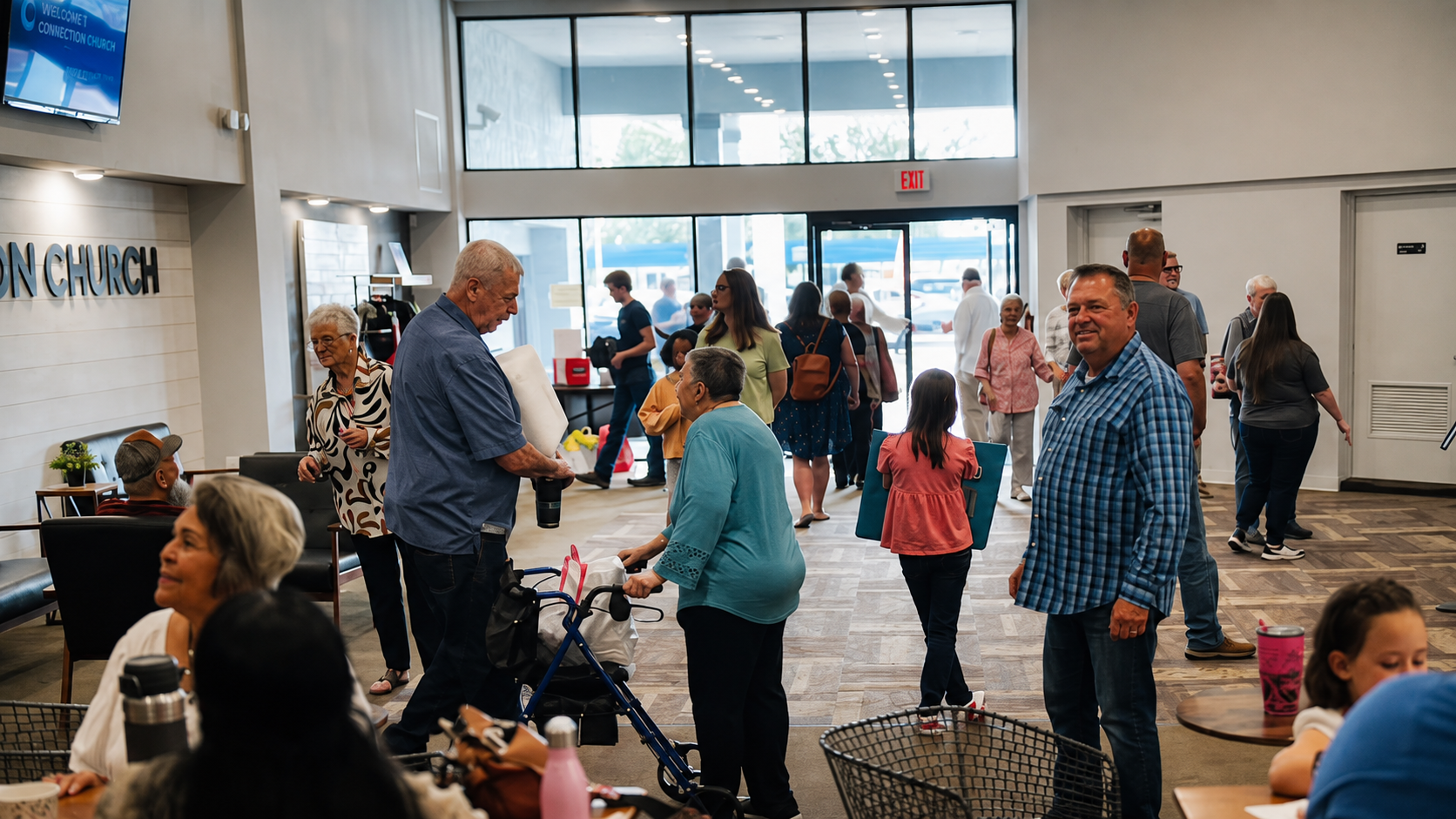 Greeters welcoming a family at the church entrance